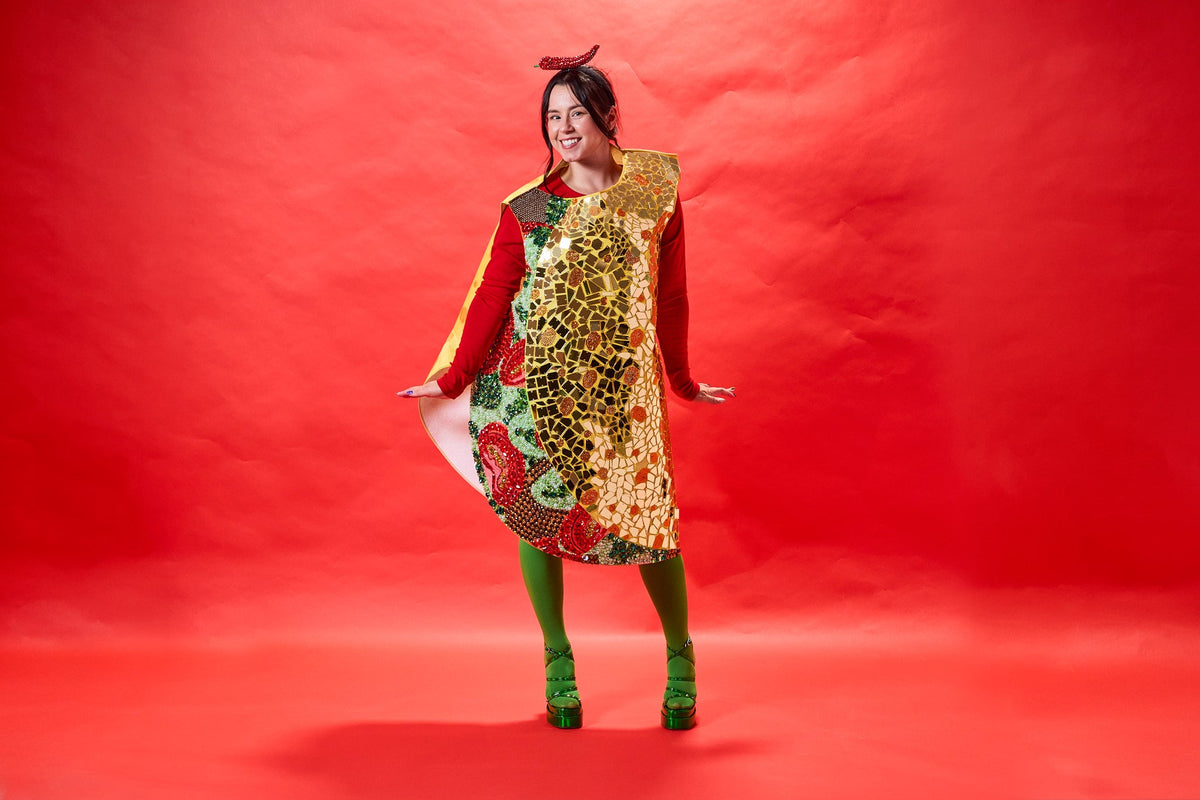 Woman wearing a blinged out taco costume standing in front of a red background