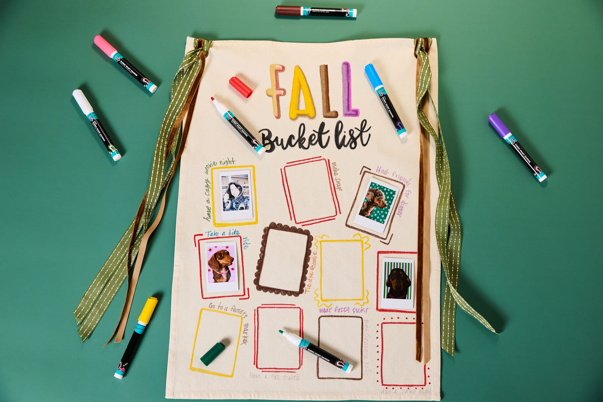 Off white canvas with Fall Bucket List painted on top with pictures of things to do. 
